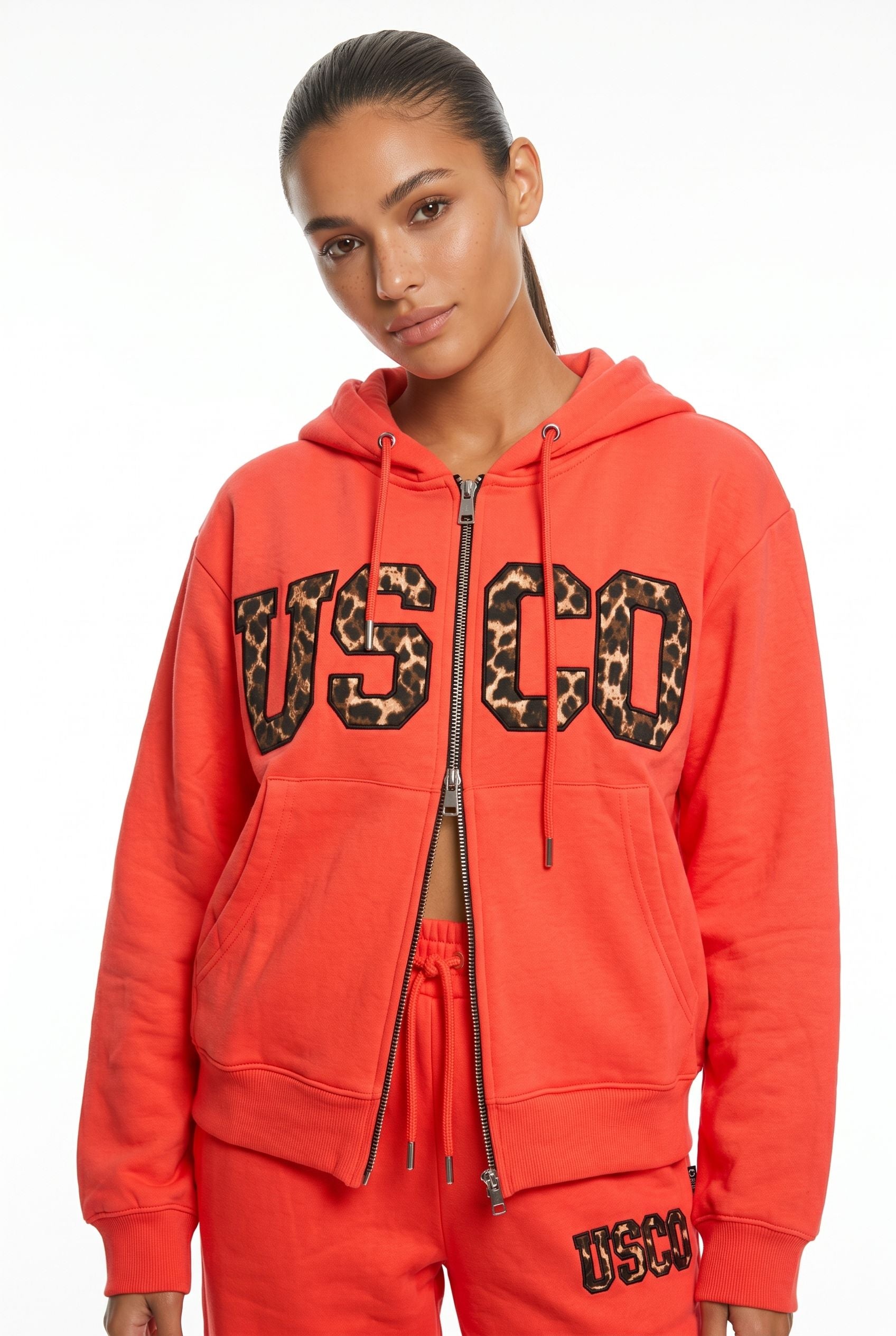 THE UNTAMED TRACKSUIT IN CORAL