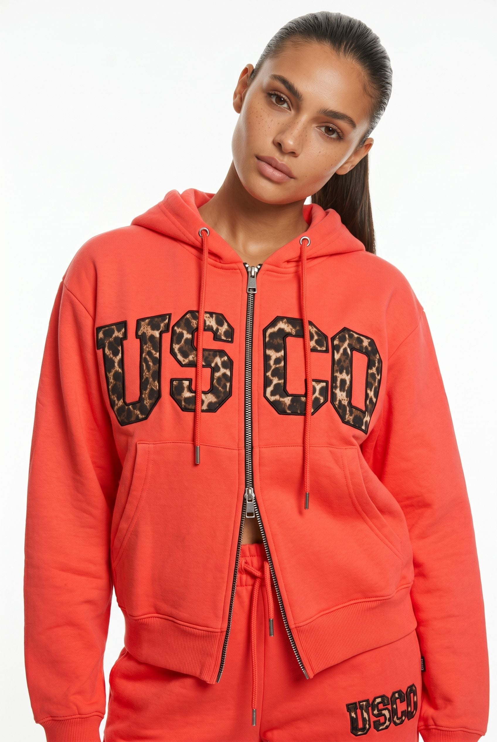 THE UNTAMED TRACKSUIT IN CORAL