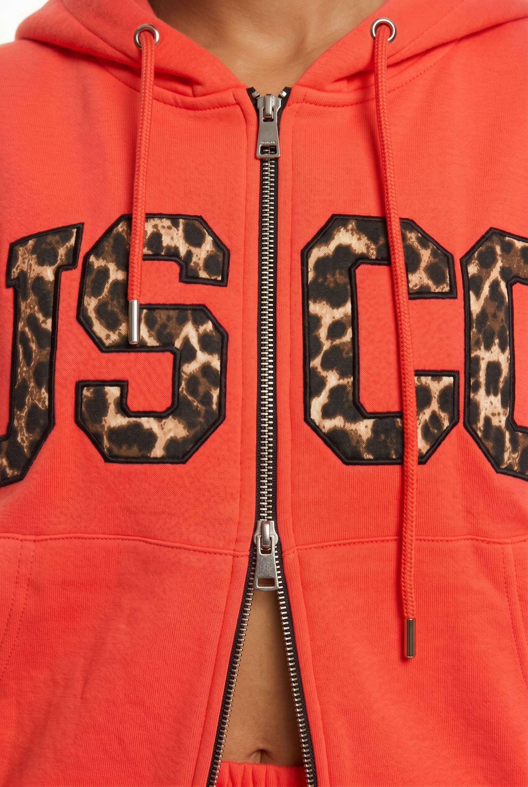 THE UNTAMED TRACKSUIT IN CORAL