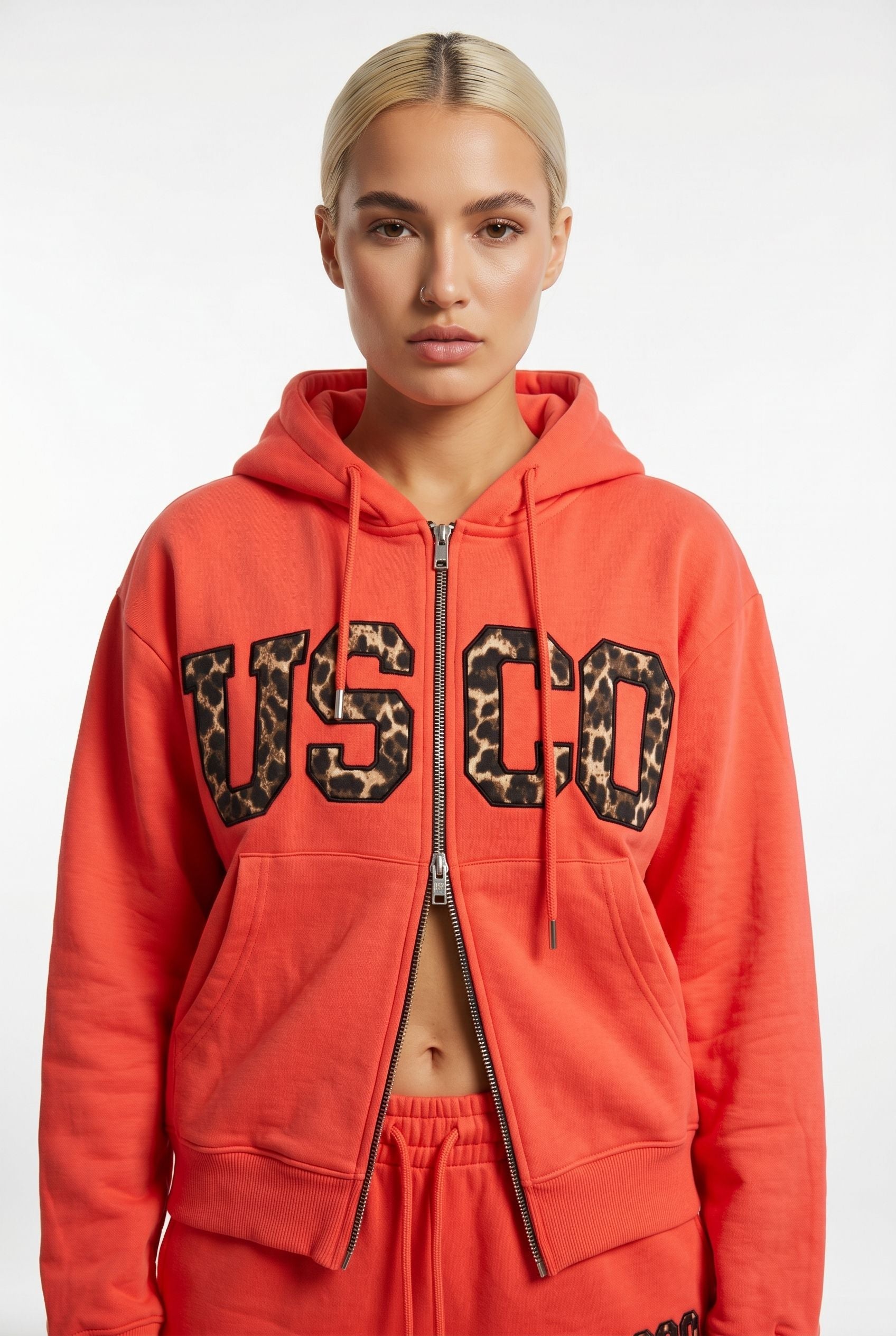 THE UNTAMED TRACKSUIT IN CORAL