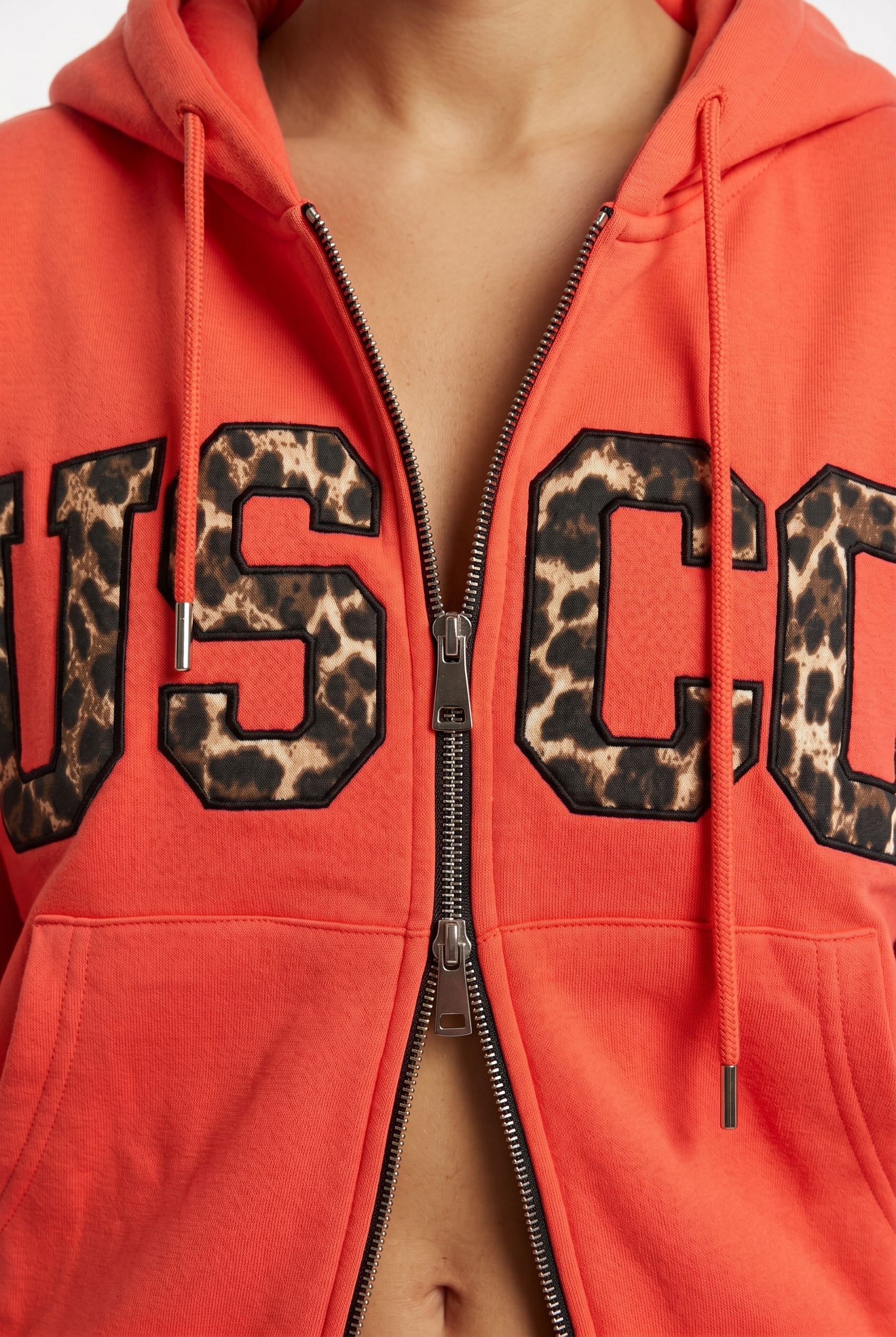 THE UNTAMED TRACKSUIT IN CORAL